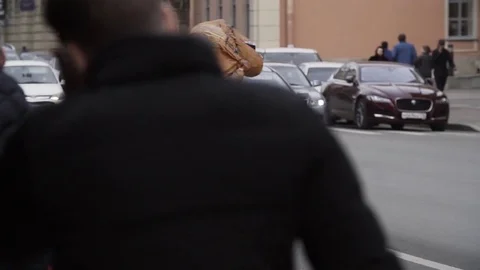 Man in t rex mascot costume walking at city street crosswalk Stock Footage 84932480