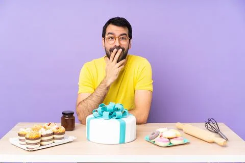 Man in a table with a big cake with glasses and surprised Stock Photos