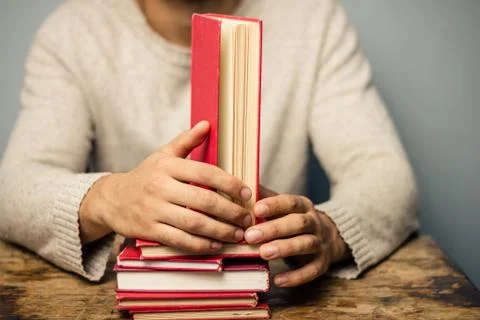 Man at table with books Stock Photos