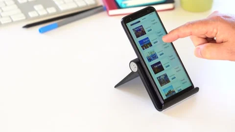 Man On Table Browsing Cities Destinations On Phone And Book Vacation. Stock Footage 145706883