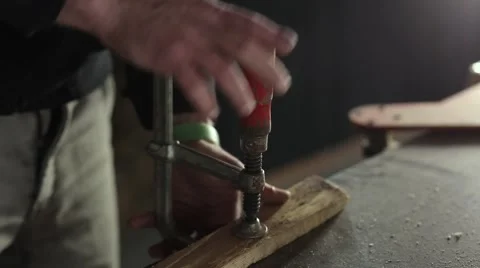 Man with a table clamp wood processing Stock Footage 59939322