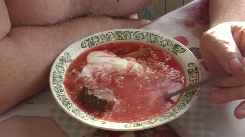 A man at the table eats Ukrainian borscht Stock Footage 171273567