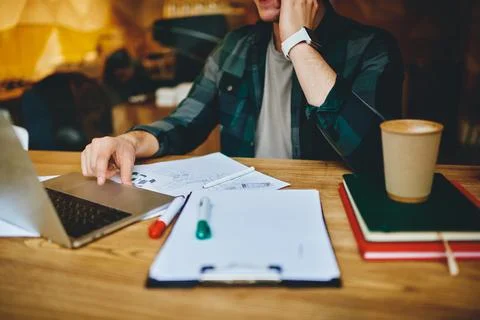 Man at table working on laptop Stock Photos
