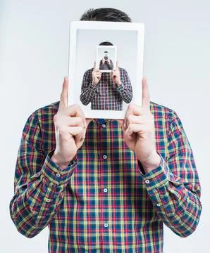 Man, tablet and recursive screen in studio for futuristic illusion, droste 库存照片