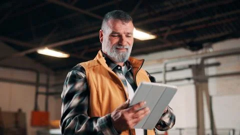 Man, tablet and scroll in carpentry workshop, check lumber order or online .. Stock Photos