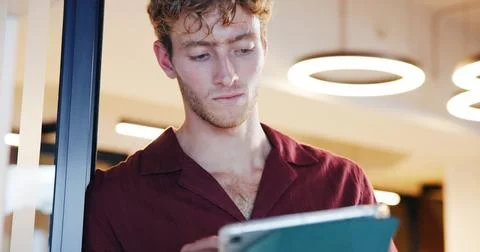Man, tablet and scroll at startup, review or thinking with notes, agenda and low Stock Photos
