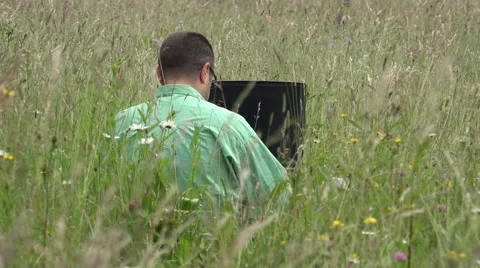 Man with a tablet and son with a ball in blossom meadow 4k Video stock 46208166