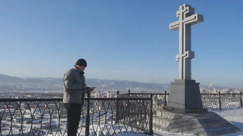 Man with tablet computer on the background of the urban landscape in winter Stock Footage 61179410