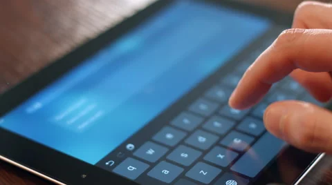 The man on tablet computer dials the message text search query. 库存影片 62878130