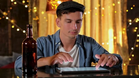 Man with a tablet drinking draft beer in a pub Stock Footage 122013959