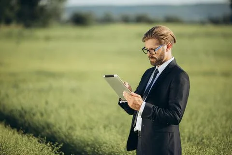 Man with tablet at field Stock Photos