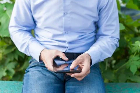 Man with tablet in hand in park. Stock Photos
