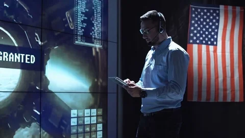 Man with tablet in mission control center Stock Footage 79077879