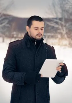 Man with Tablet Outside in Winter Decor Stock Photos