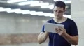 Man with tablet pc stands inside underground station HD Footage