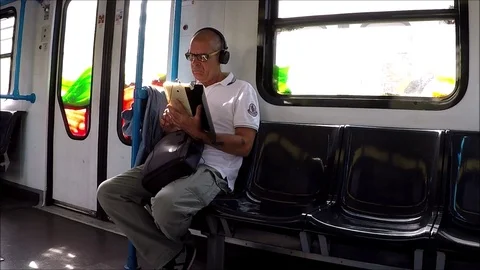 Man with tablet on the train Stock Footage 118836956