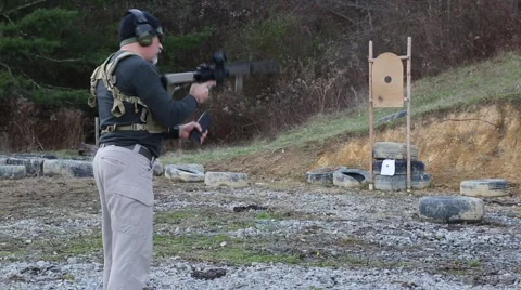 Man in tactical gear loading, priming and unjamming an AR-15 target Video stock 59104781