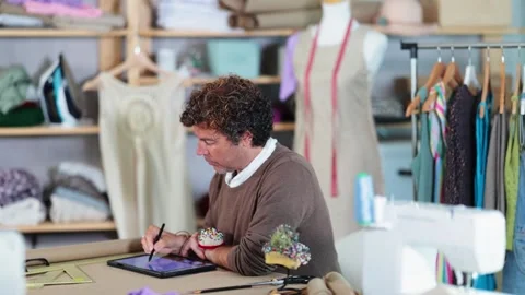 Man tailor makes pattern using tablet Stock Footage 327693866
