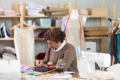Man tailor makes pattern using tablet Stock Photos