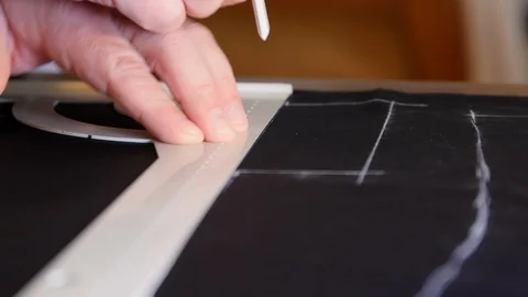 Man Tailor Making and tracing lines On silk lining. Close Up Of Hands Tracing Stock Footage 127472732