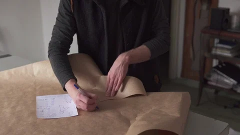 Man tailor making clothing pattern while work in workshop Stock Footage 100617231