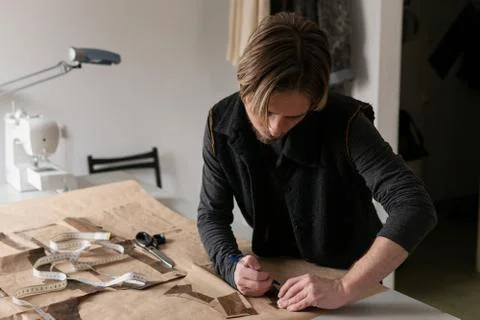 Man tailor making clothing pattern while work in workshop Stock Photos