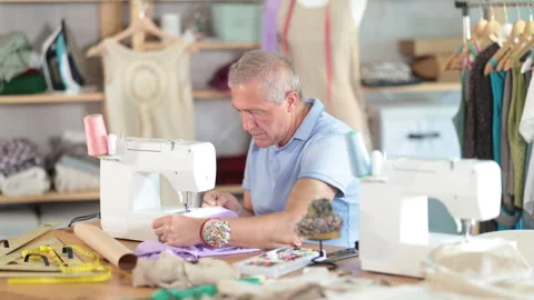 Man tailor sews on sewing machine in workshop Stock Footage 342130857
