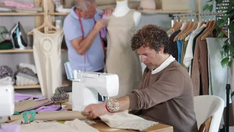 Man tailor at work, other man work with mannequin in background Stock Footage 330039807