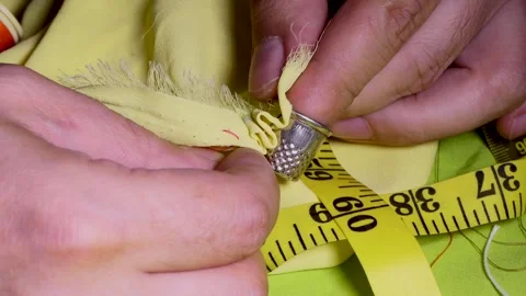 Man tailor's hands stitching a fabric Stock Footage 250457357