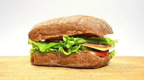 Man Take and Puts Delicious Sandwich of Rye Bread on a table. 4K Video stock 49918157