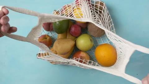 Man take avocado from reusable bag with tropical organic fruits Stock-Footage 203240744