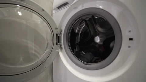 Man take the Clothes from Washing Machine Stock Footage 153265978