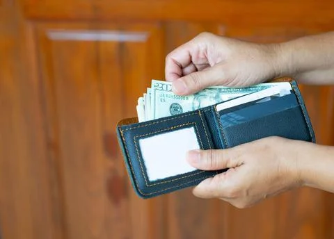 The man take dollars banknotes in wallet with credit cards. Stock-Fotos