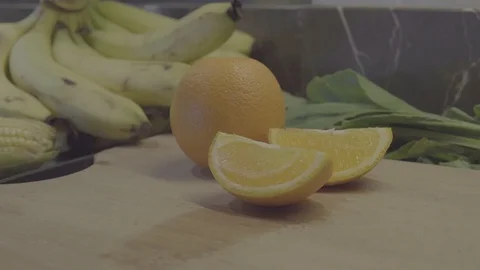 Man take half of orange from cutting board Stock Footage 92845889
