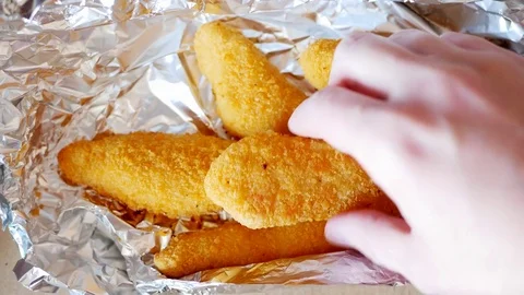Man take one chicken strip. Stock Footage 70402526