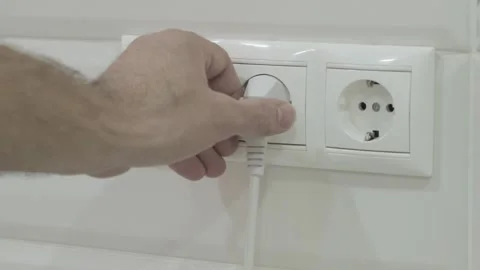 Man take out plug Into electrical socket Stock-Footage 276776804