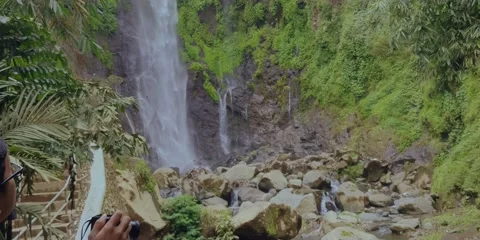 Man Take Picture of Waterfall Stock Footage 144159528