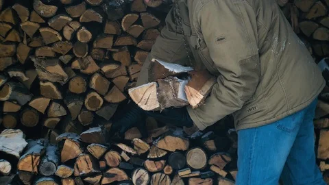 Man take wood pile from stack Stock Footage 86564192