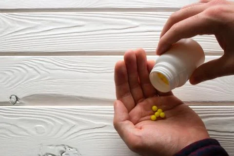 Man takes ascorbic acid on a white background Stock Photos