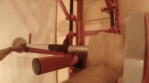 Man Takes Off Barbell From the Wall Bars and Squats With it Stock Footage 62475628