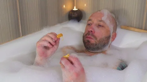 Man takes a bath in the bathroom in isolation time Stock Footage 127857243