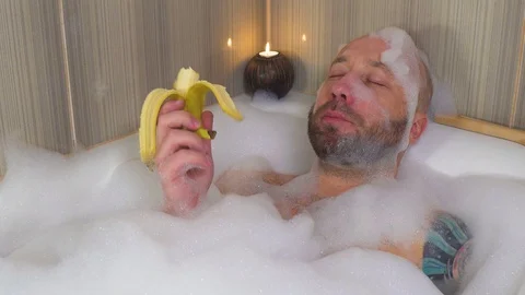 Man takes a bath in the bathroom in isolation Stock Footage 127857250