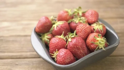 Man takes berry from the plate. Stock Footage 154819074