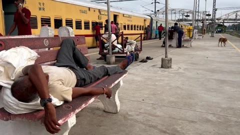 : A man takes break and naps at Varanasi Cantt railway station Stock Footage 285829411
