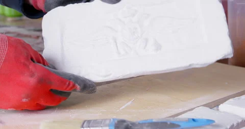Man takes brick plaster mold with pattern checking angles Stock Footage 172118335