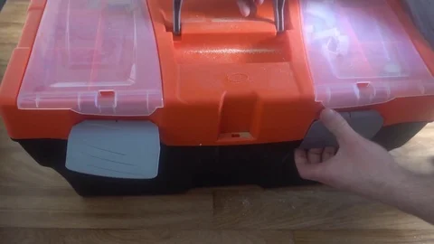 The man takes the cable out of the Toolbox,and then closes it Stock Footage 75912526