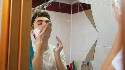 A man takes care of his beard, a guy applies shaving foam Stock Footage 264887159