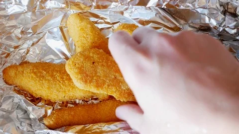 Man takes chicken strips. Time lapse. Stock Footage 70402420