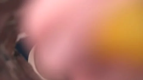 The man takes the chips from the pack and eats. Close-up of a man's face. View Video stock 233331865