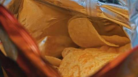 Man Takes Crispy Potato Chips from a Pack with His Hands Stock Footage 263802961